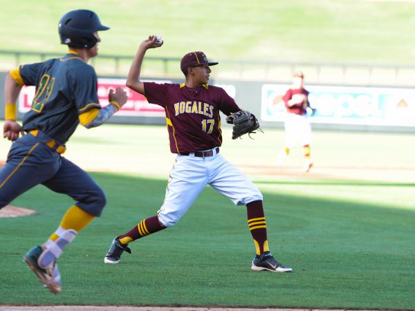 Nogales pitcher Juan Vega throws to first. Photo by Mark Jones/maxpreps.com