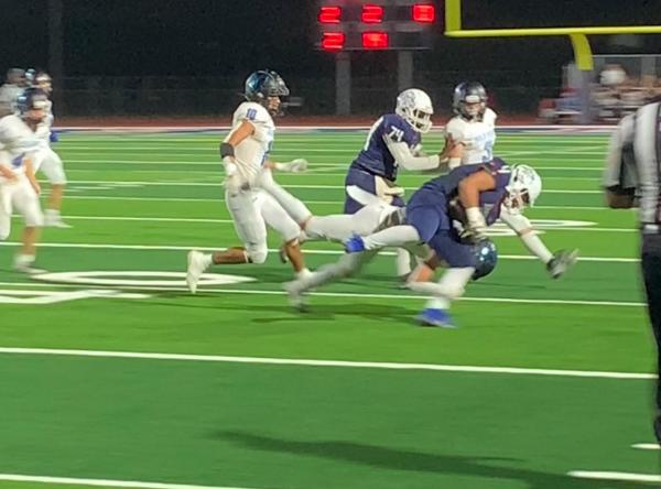 Kevin Tortolero delivers a hit to a Gila Ridge defender on a rushing attempt September 30th in Phoenix. (Oliver Fell/AZPreps365)