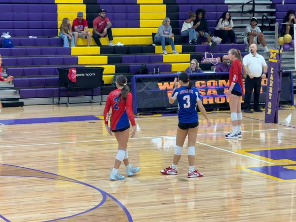 This picture shows #3 Alayna Austin (wearing blue) playing alongside #2 Macie Bradshaw (in red).